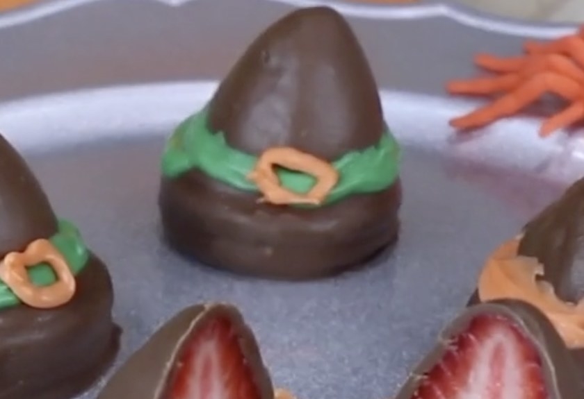 A strawberry coated in chocolate to look like a witch&#x27;s hat