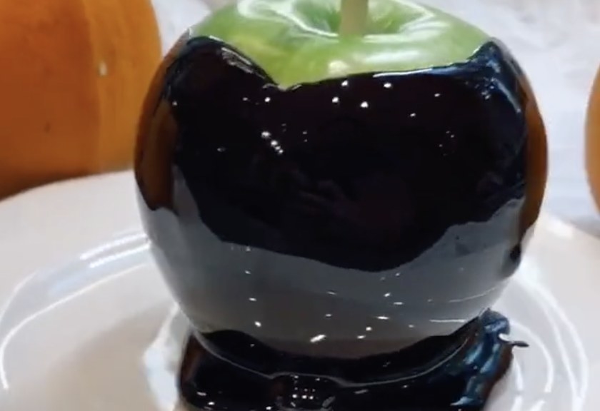 A candy apple with black coating