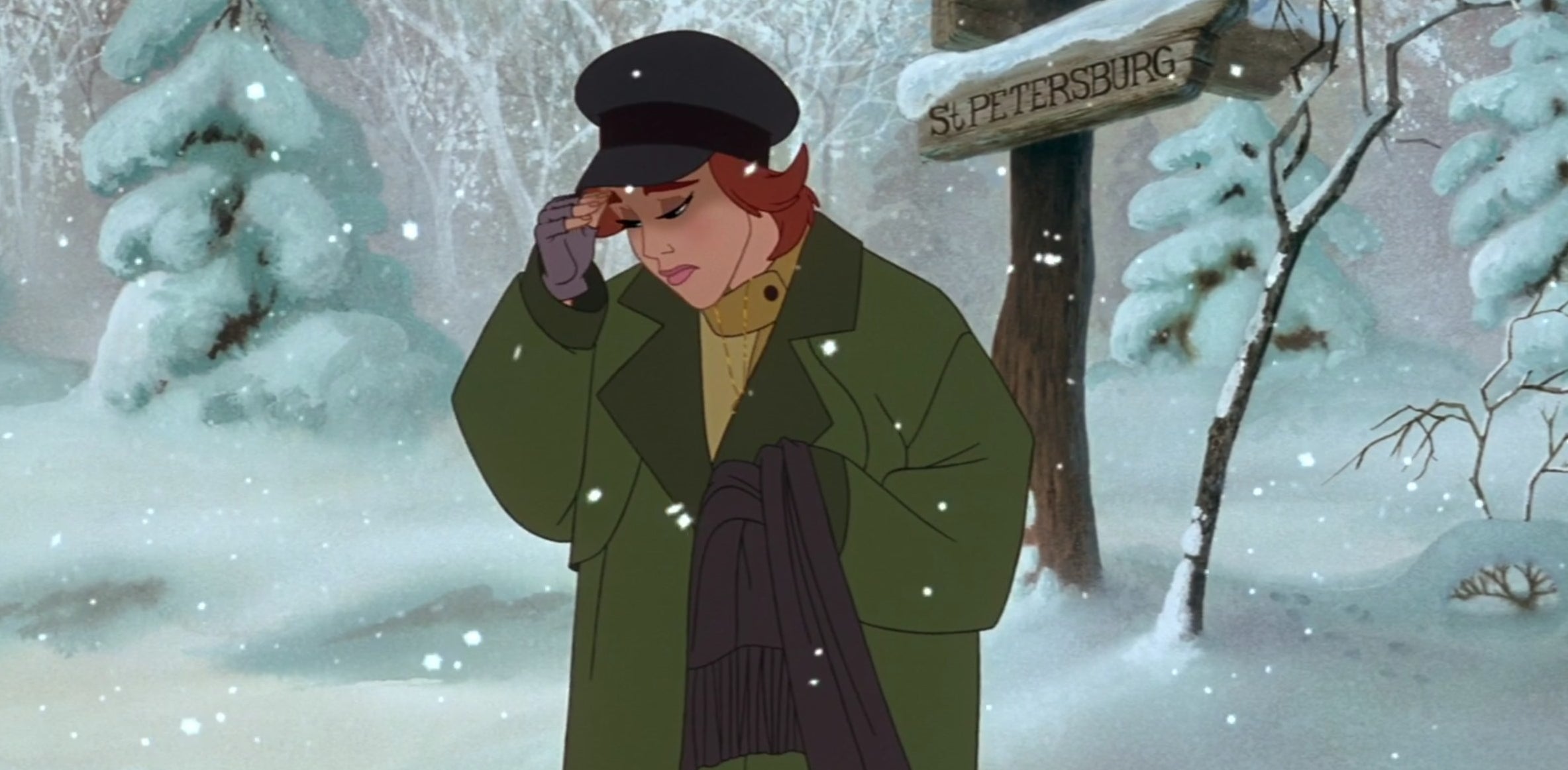 A woman wearing a large jacket stands in the snow