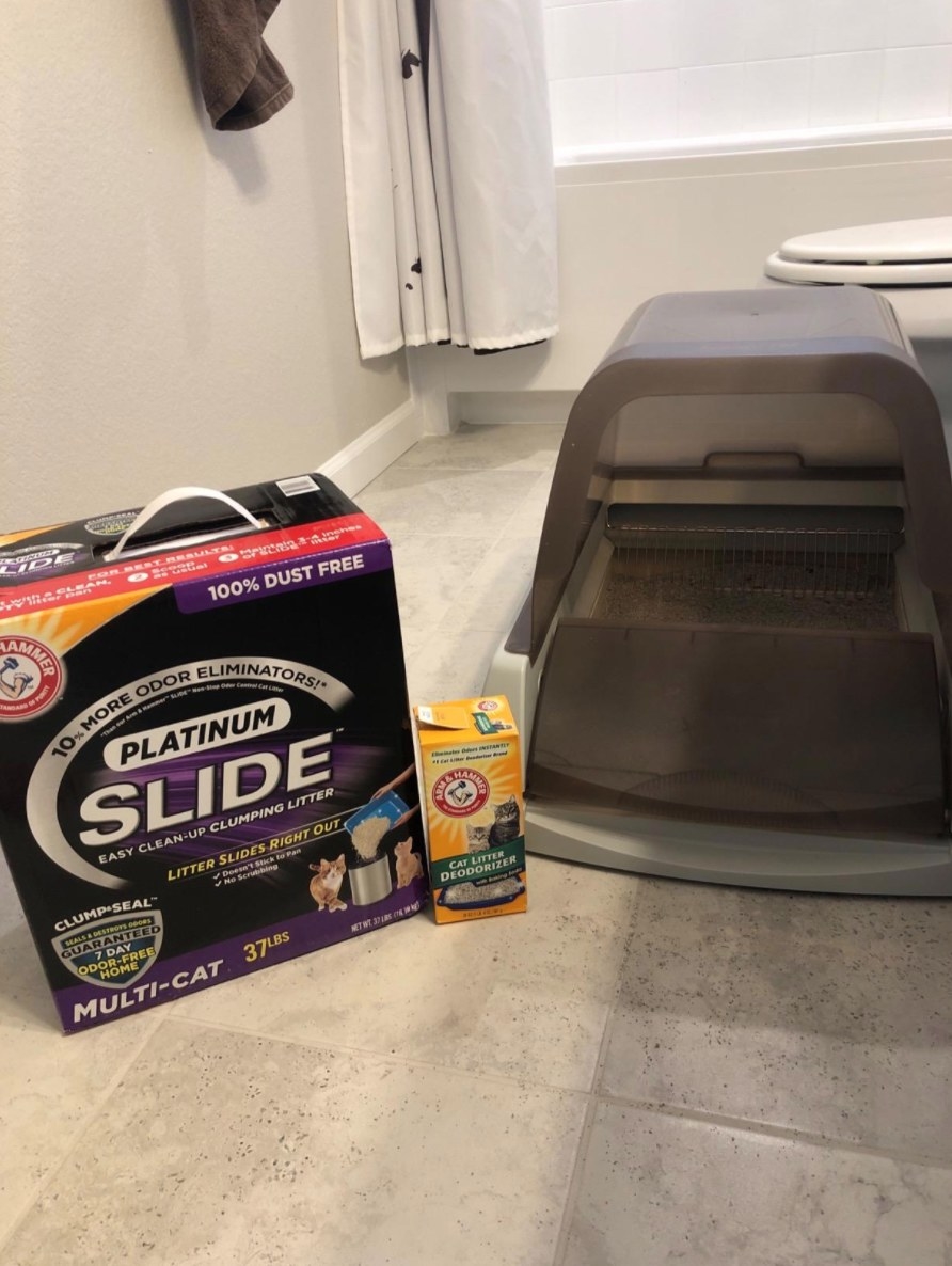 A reviewer&#x27;s image of the automatic self-cleaning hooded litter box in gray