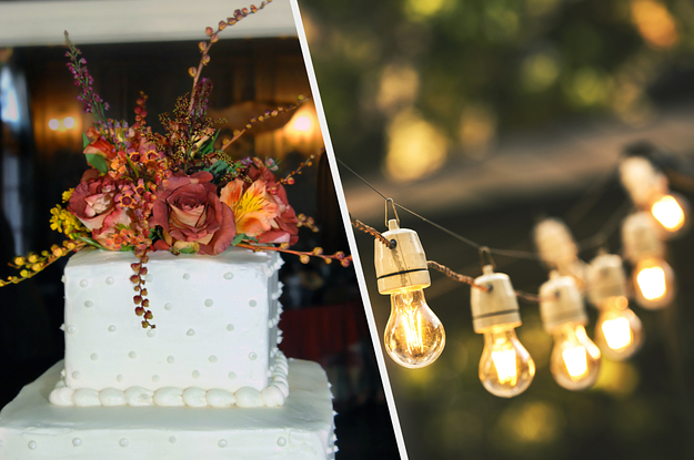 A flower-topped wedding cake next to a strand of lightbulb string lights