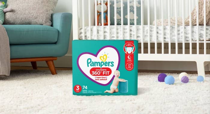 A box of Pampers® Cruisers 360° Fit™ diapers sitting on the carpet in a nursery