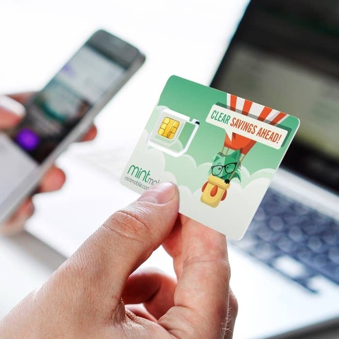 A hald holding the Mint Mobile card