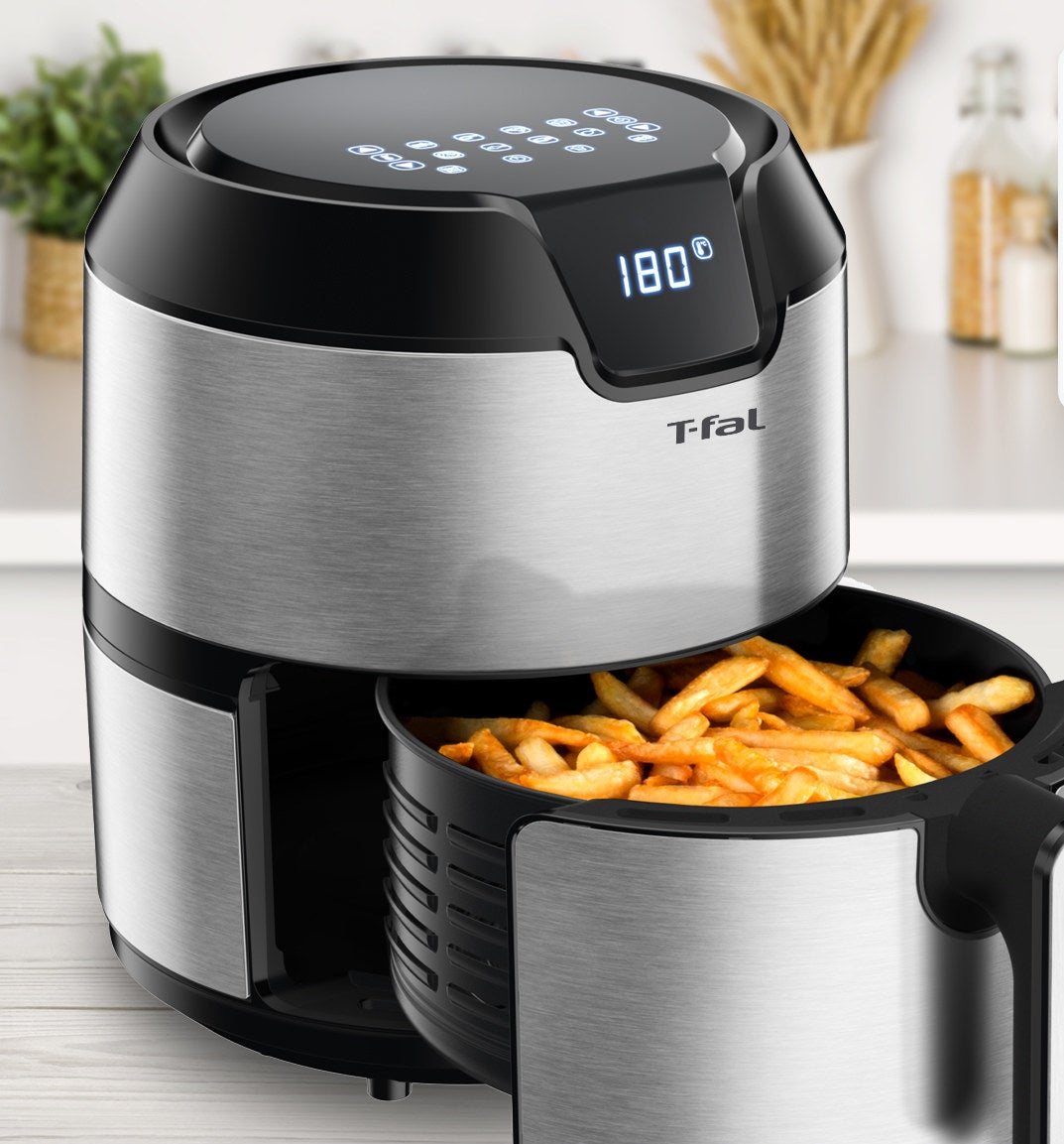 The air fryer with the interior basket full of crispy French fries