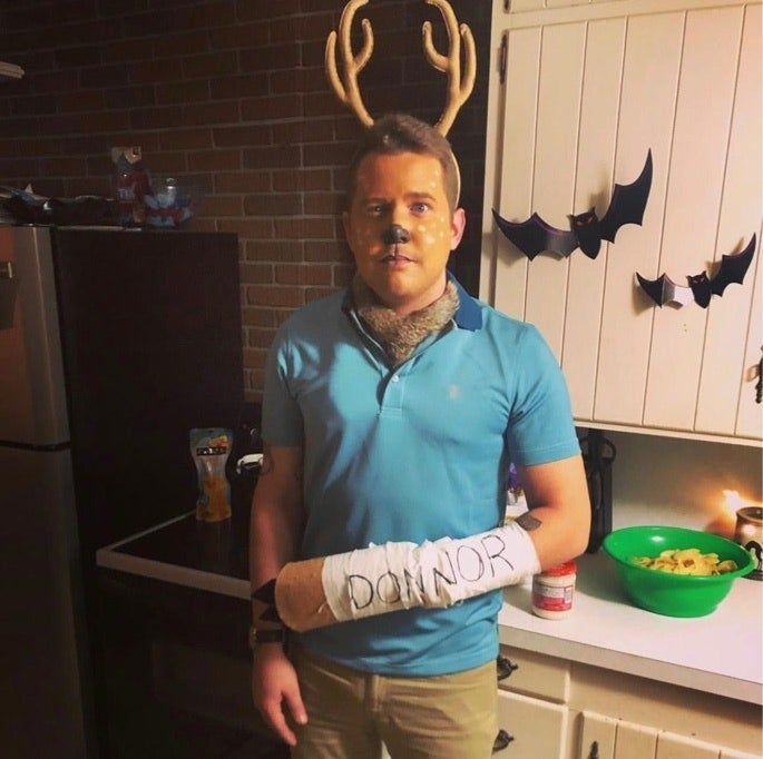 A man with deer makeup, antlers, a blue shirt, and a cast that says &quot;Donnor&quot;