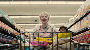 Harley Quinn running with a shopping cart