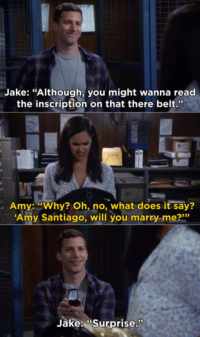 Amy reading the inscription on the Halloween Heist belt and Jake proposing