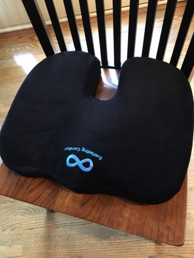 A black memory foam seat cushion on a chair