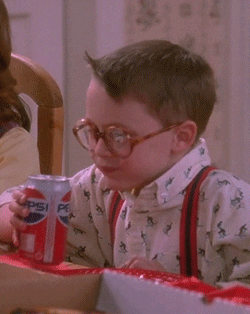 Kieran Culkin taking a sip of Pepsi at the table.