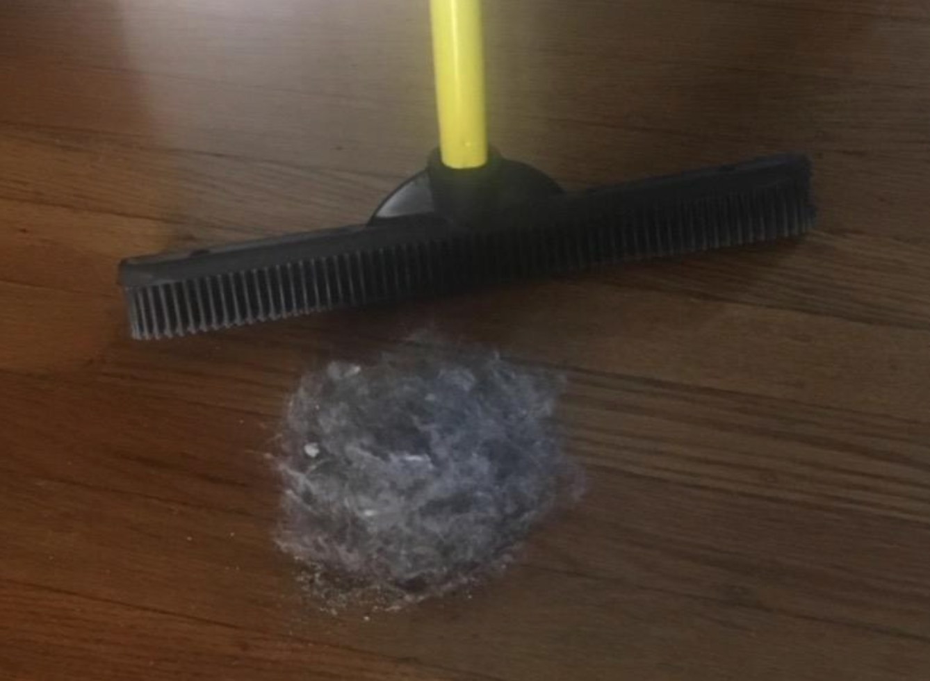 The reviewer&#x27;s image of the pet hair removal brush with a pile of hair
