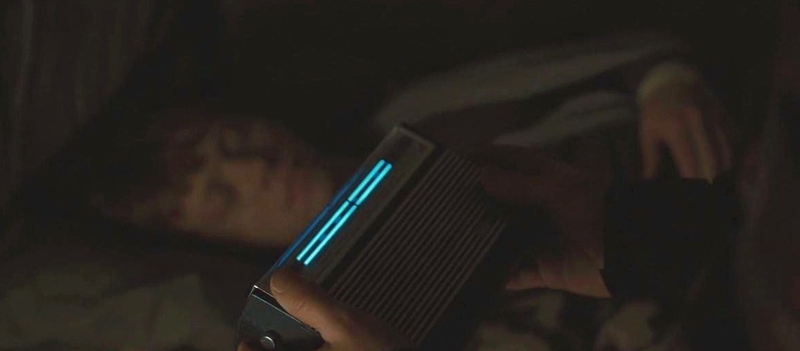 Harry holding a radio near Ron while Ron sleeps