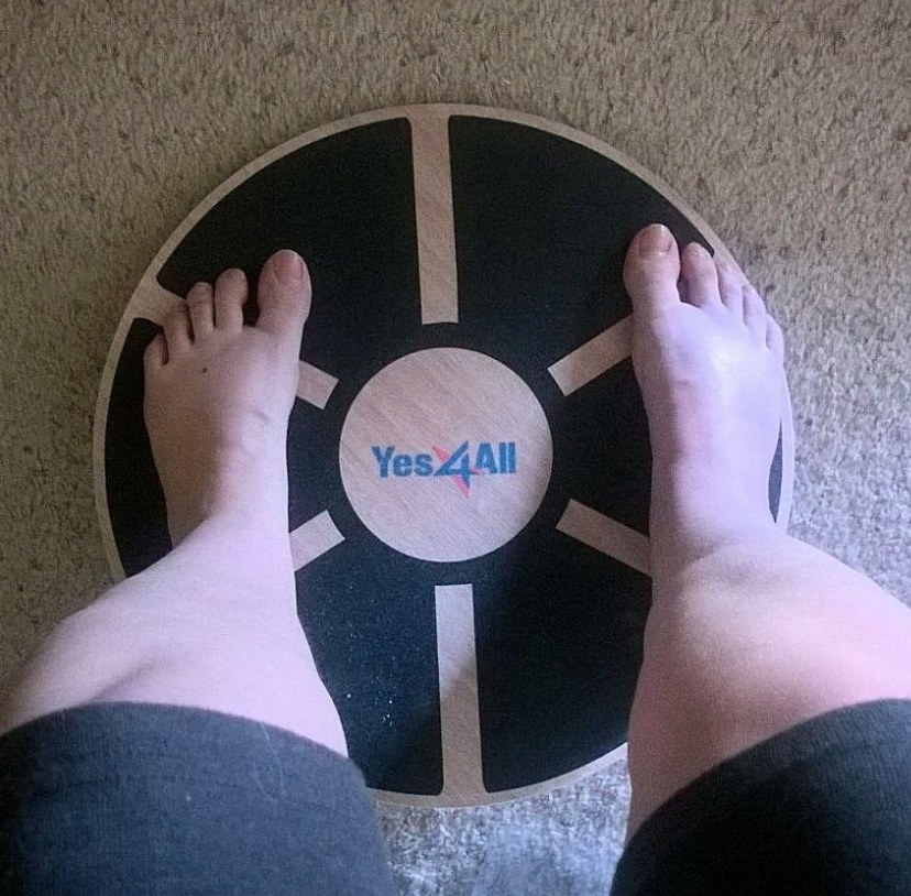 A person&#x27;s legs standing on a stability board