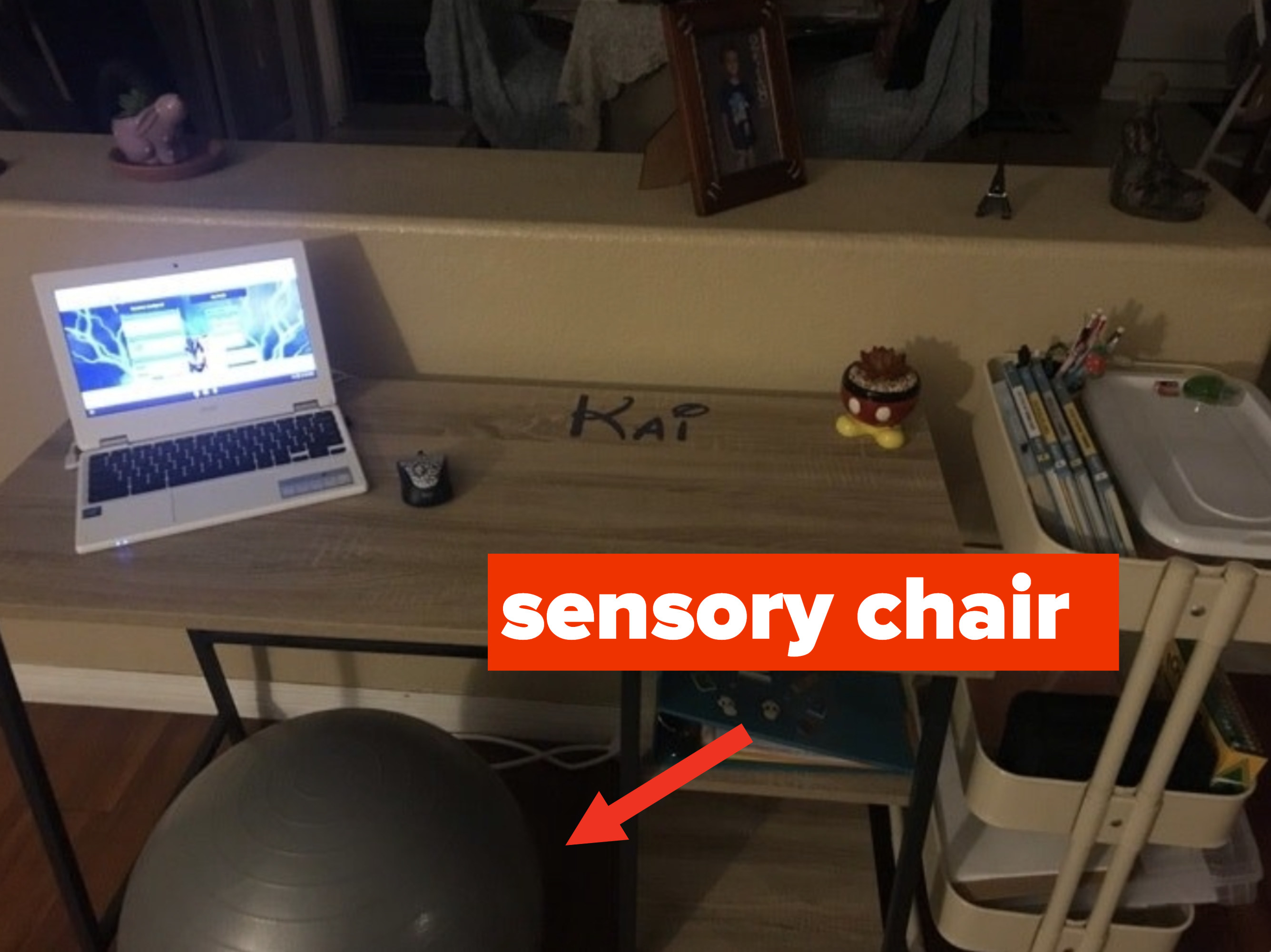 A student&#x27;s at-home desk with sensory chair.