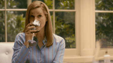 Laura Linney chugging a glass of red wine.