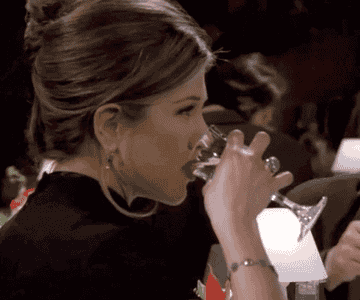 Jennifer Aniston in &quot;Friends&quot; drinking a glass of wine very quickly.