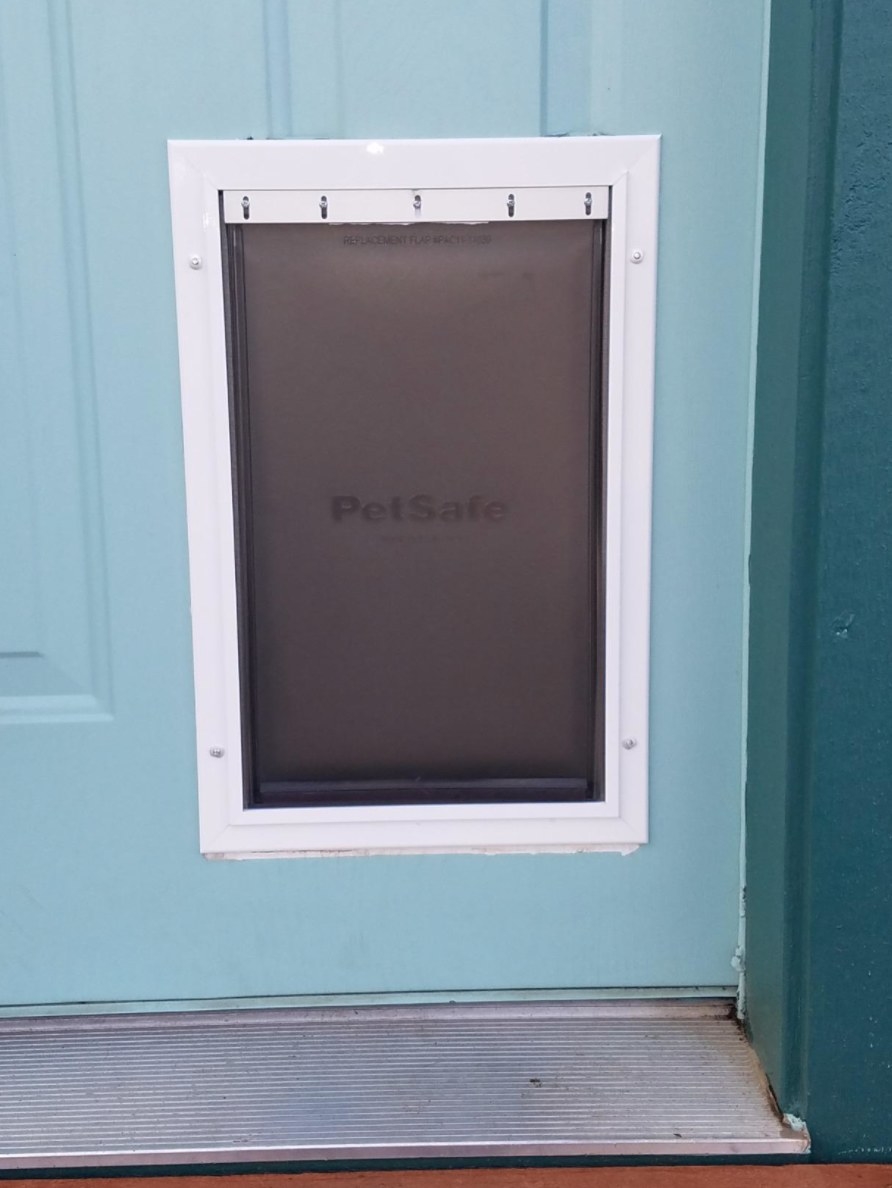A reviewer&#x27;s image of the doggie door installed in their home