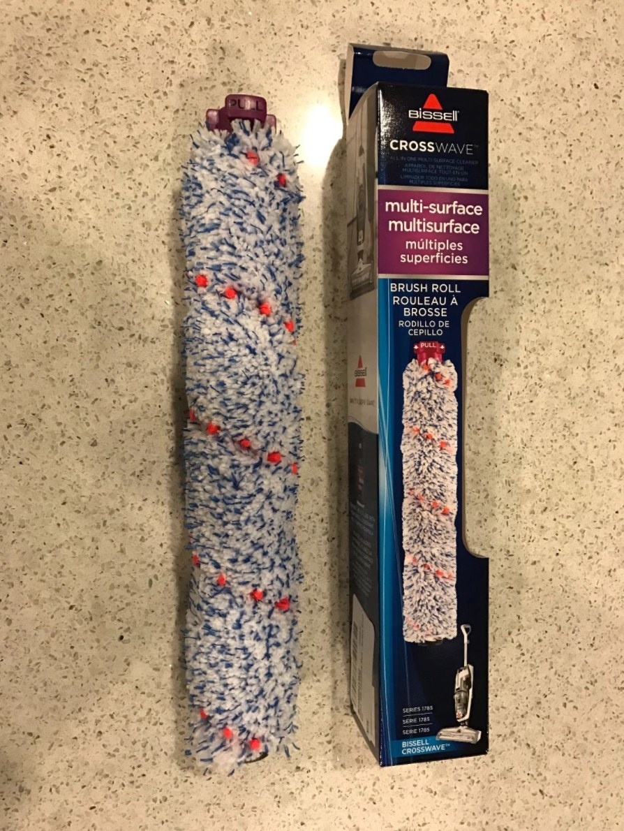 A reviewer&#x27;s photo of the multi-surface pet brush and its packaging