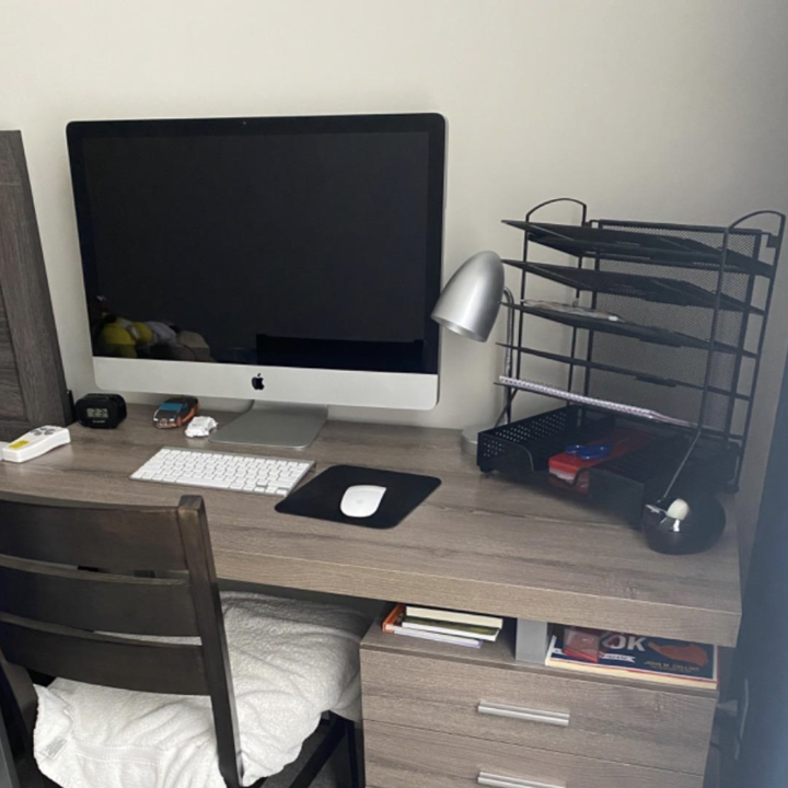 The organizer taking up a corner of a desk and leaves ample room for a computer and desk lamp