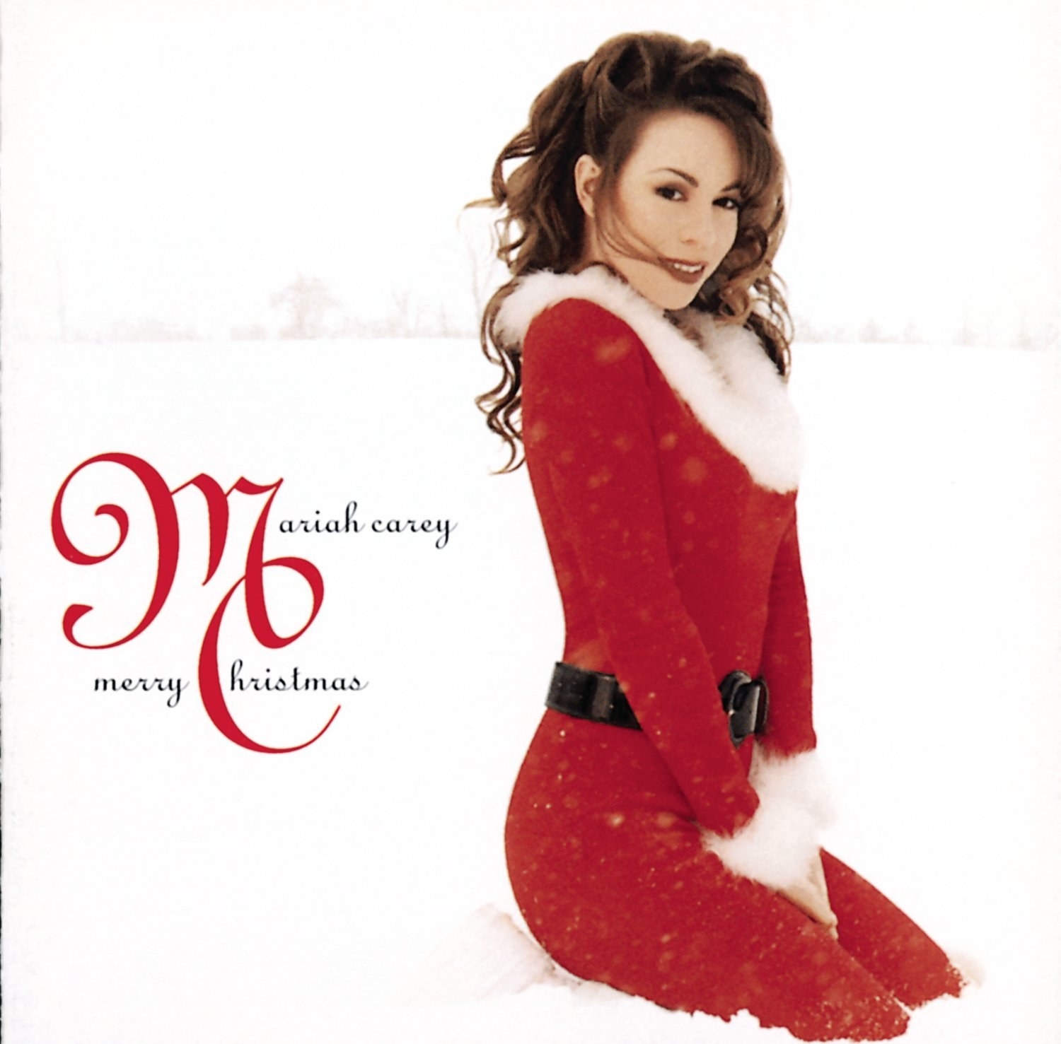 album cover of Merry Christmas showing Mariah Carey in a red jumpsuit lined with white fur kneeling in the snow