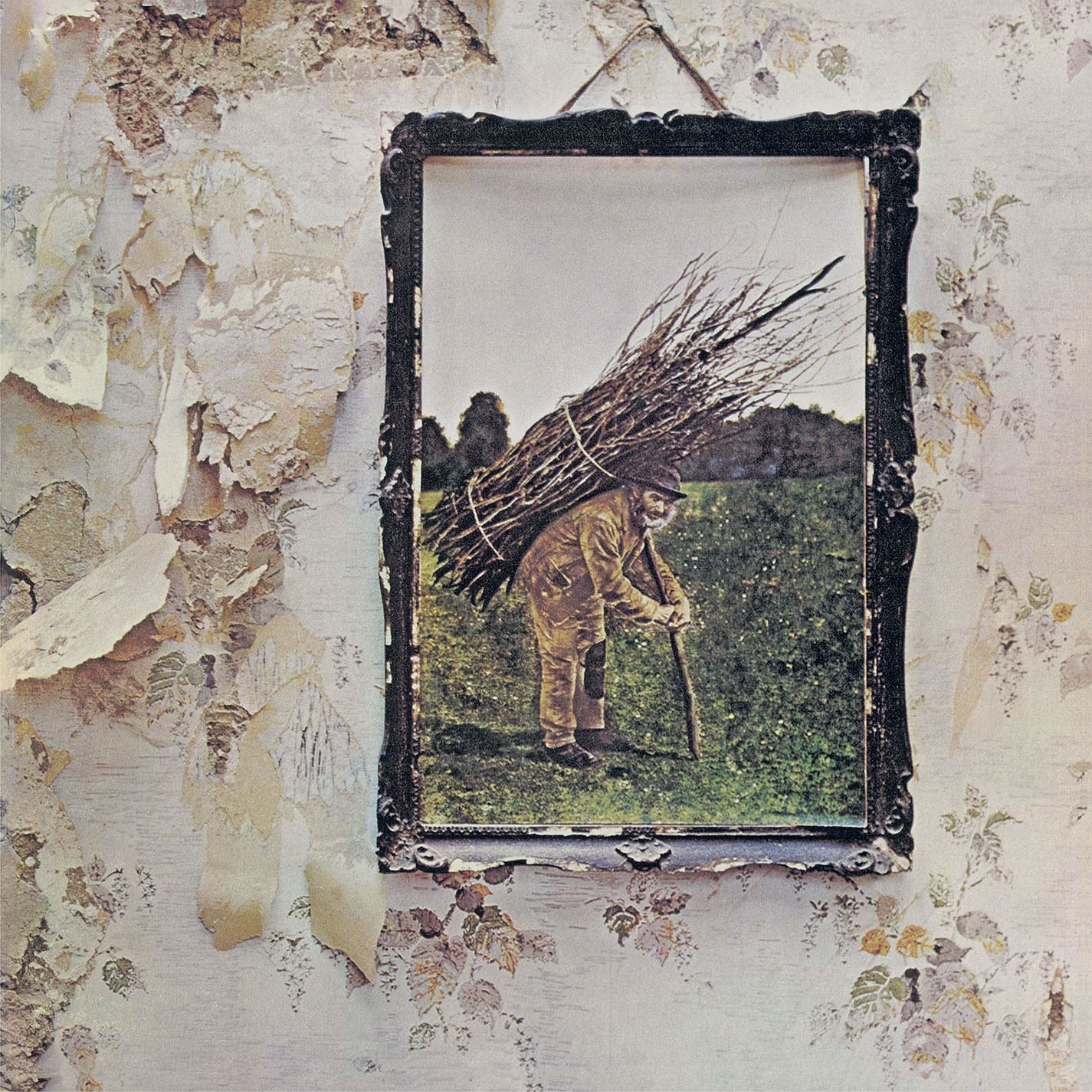 album cover of Led Zeppelin IV showing a framed image of an old man carrying a bundle of sticks on his back, hanging on a wall with worn and peeling wallpaper