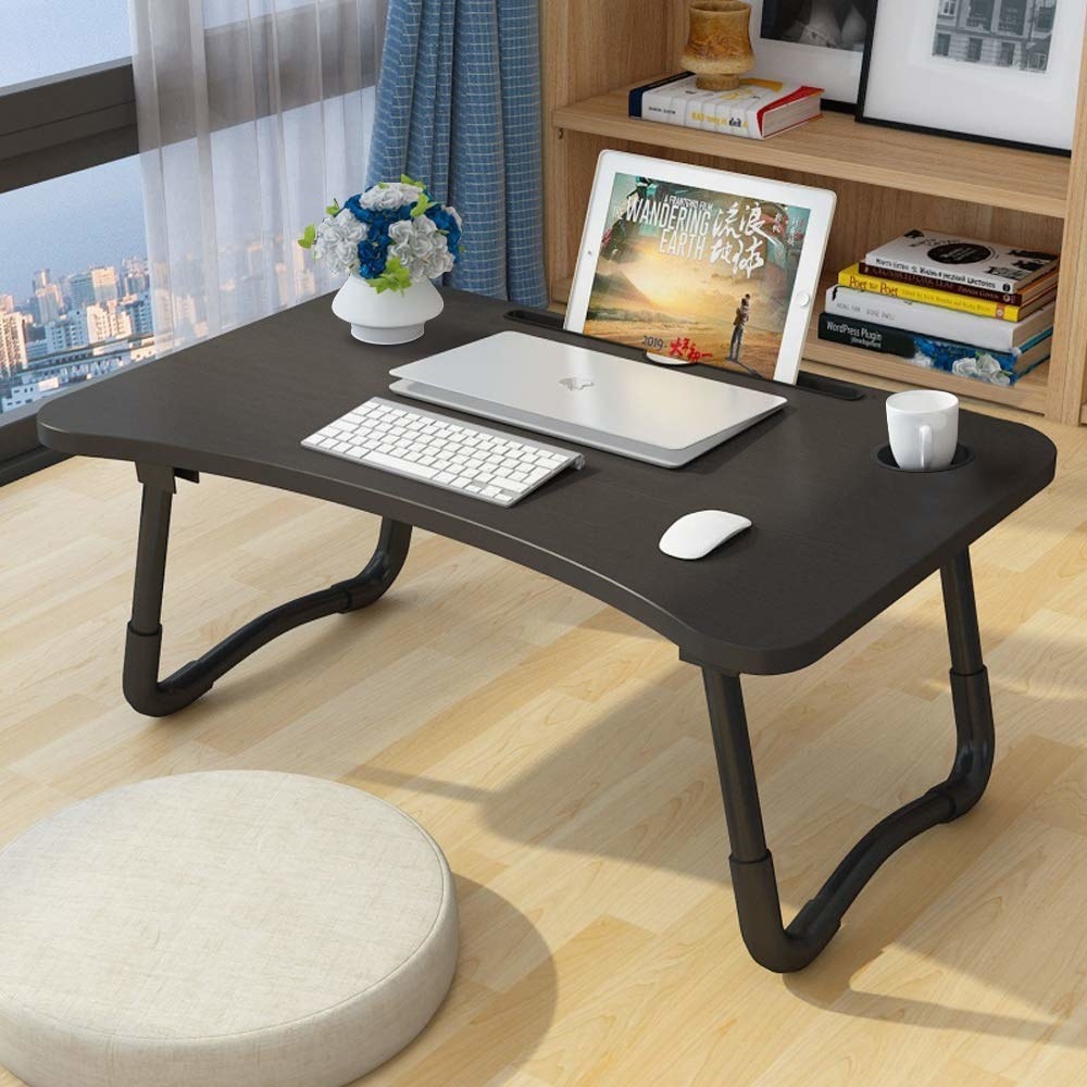 A laptop desk with a laptop and a mouse on it