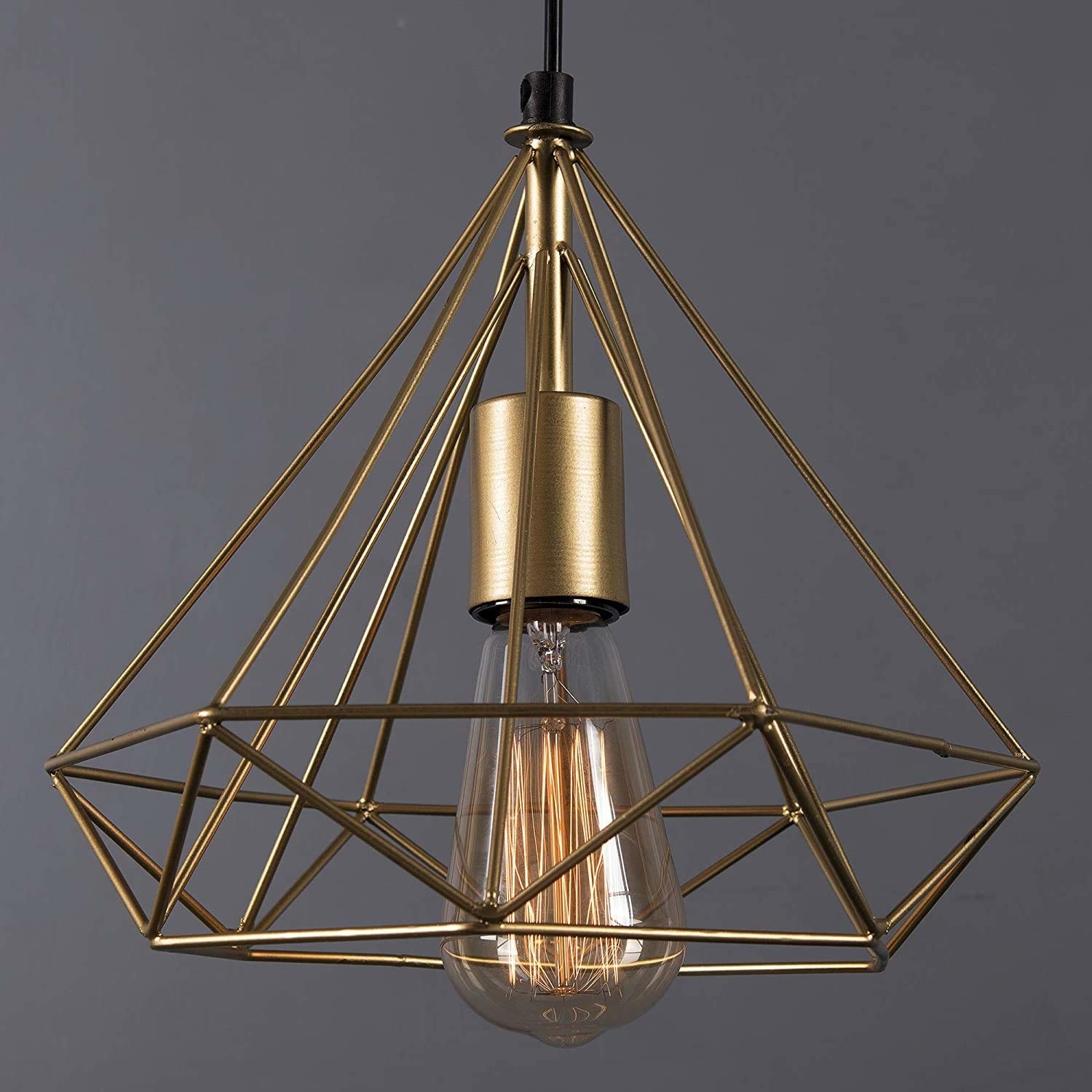 A golden pendant light with an Edison bulb.