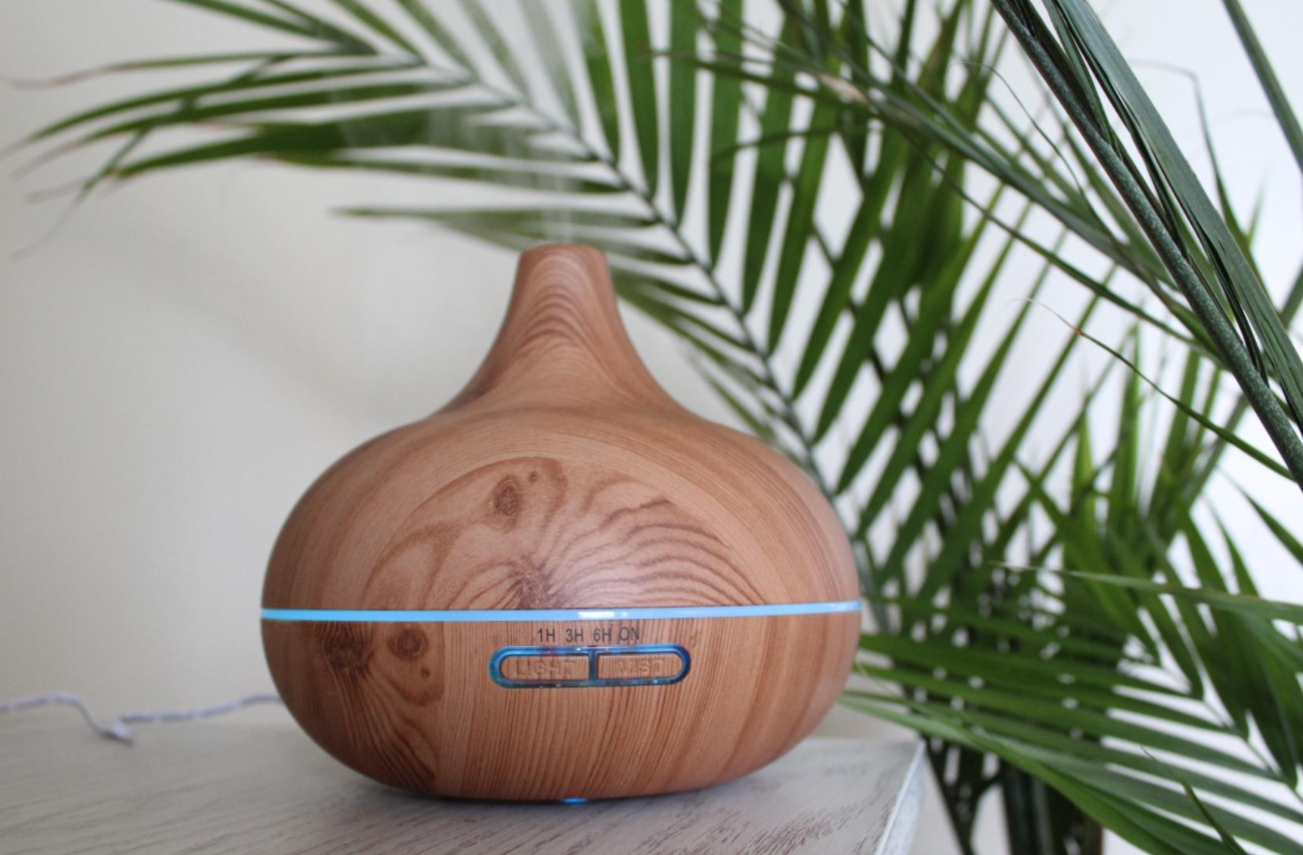 A reviewer&#x27;s photo of the diffuser with blue light settings and two buttons