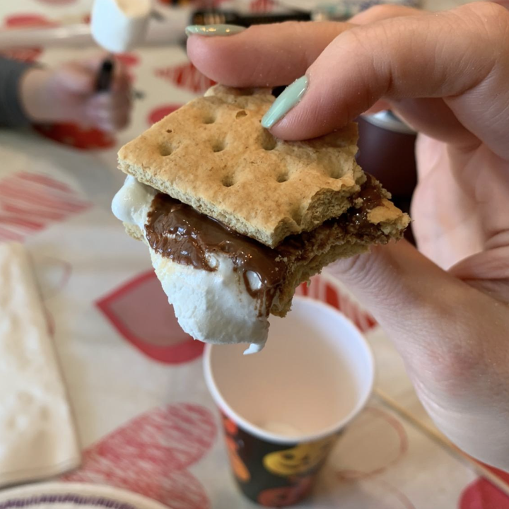 reviewer holding a finished s'more 