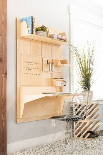 Wall mounted natural birchwood desk with tabletop, shelves, outlet charging station, and dry erase panel 