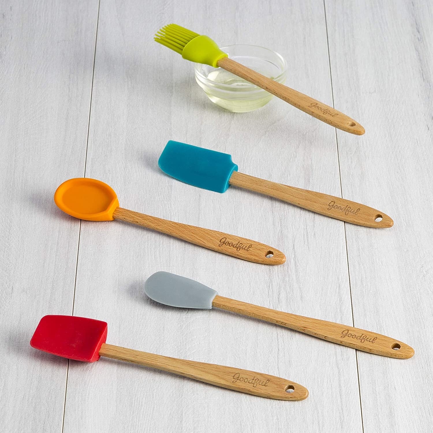 The red, gray, orange, blue, and green utensils