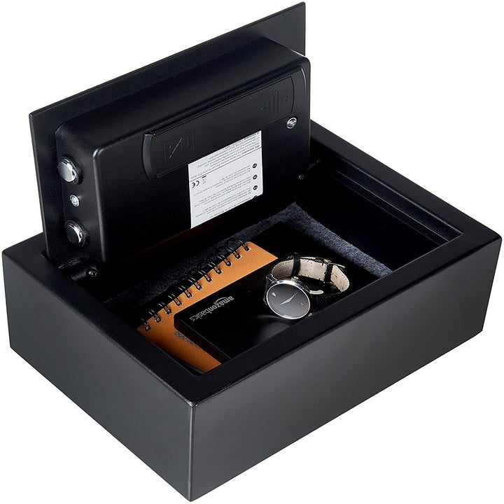 Safe open with valuables like watch inside