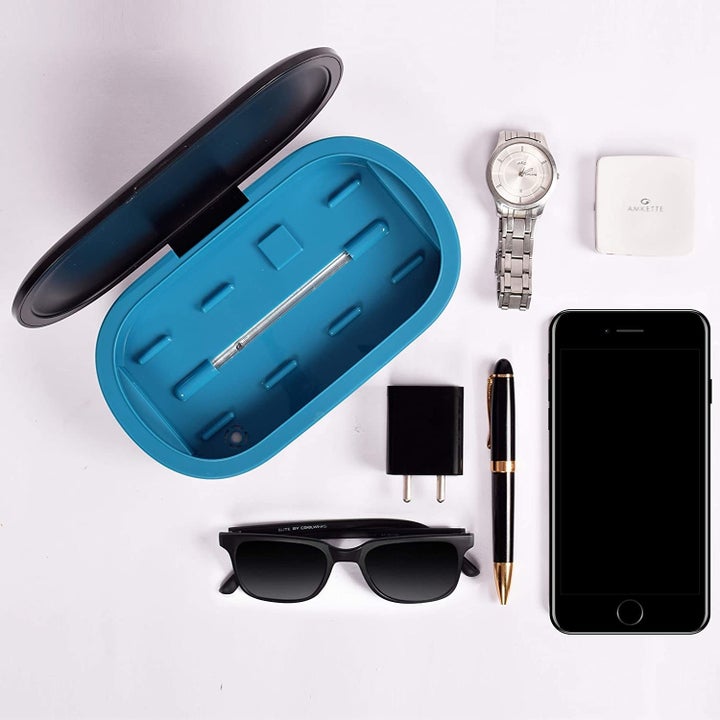 The bix pictured with a watch, sunglasses, pen, phone and other items that can be sterilised in it.