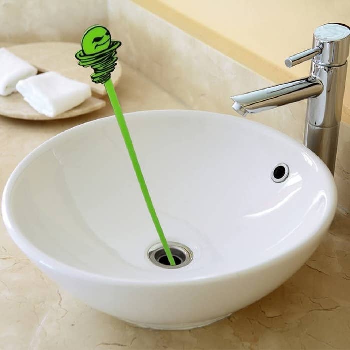 A drain-snaking tool in a sink