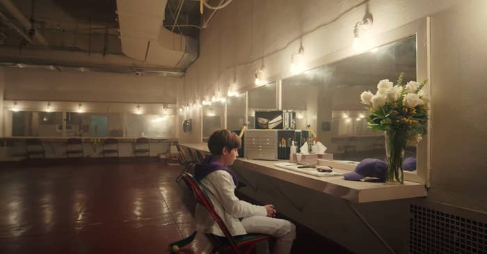 Young Justin sits alone backstage