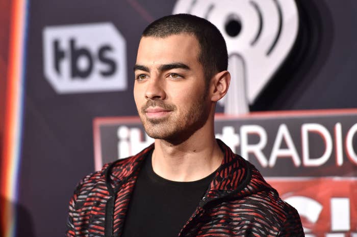 Joe Jonas wearing a t-shirt and jacket