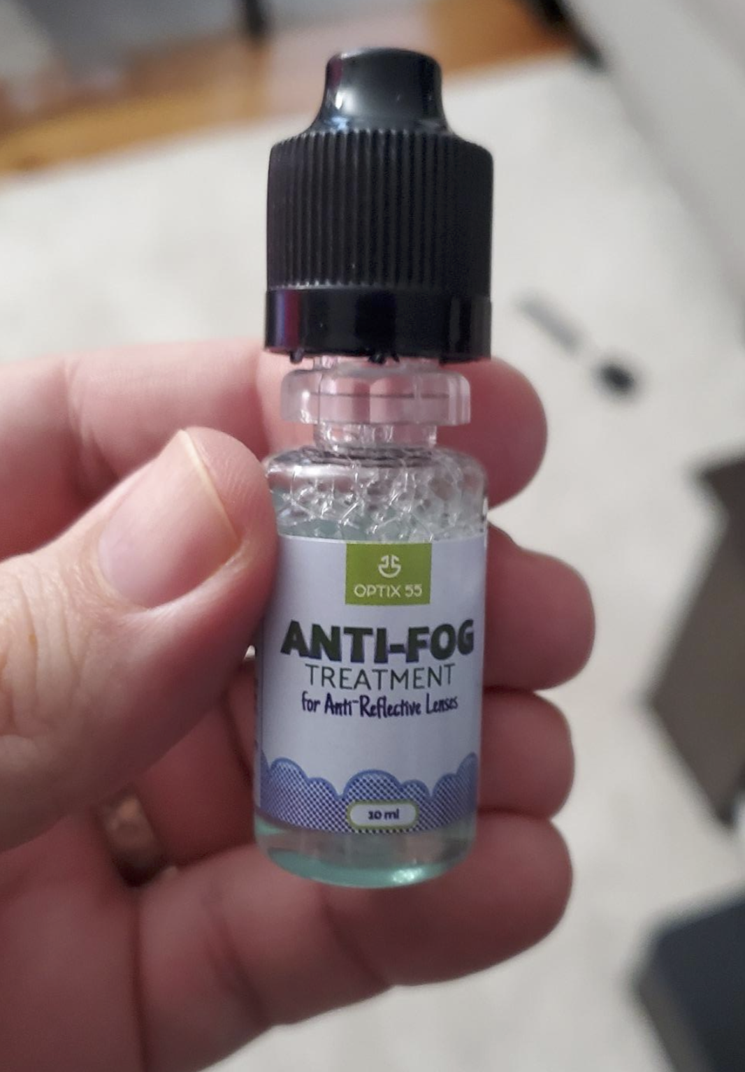 reviewer&#x27;s hand holding the anti-fog treatment