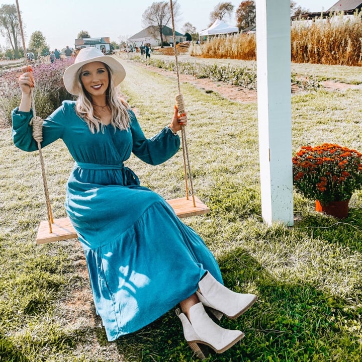 Reviewer wearing the teal version with a white hat and white booties