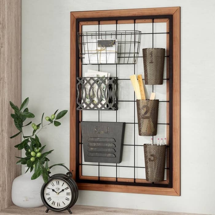 Wall organizer with wooden frame and black metal elements 