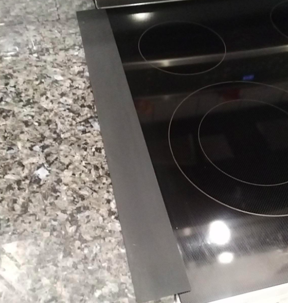 reviewer photo of stove gap cover placed over the gap between their stove top and kitchen countertop 