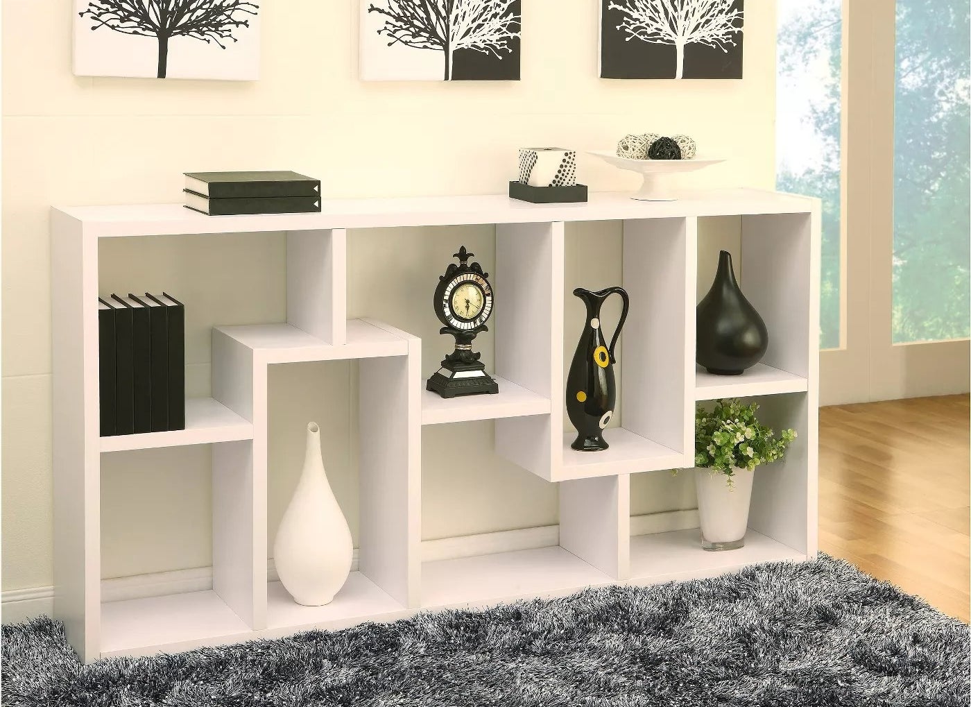 A white bookcase with geometric shelving