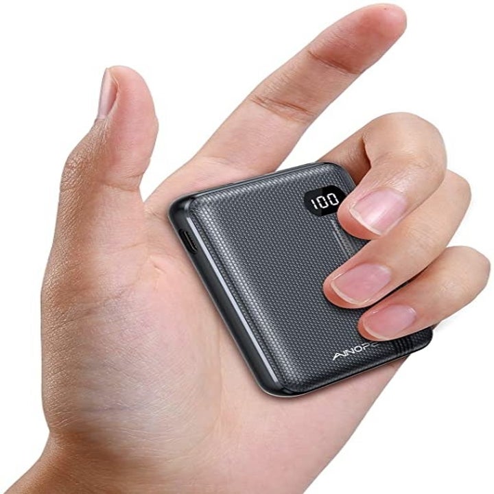 Close up of the AINOPE portable charger in a model's hand