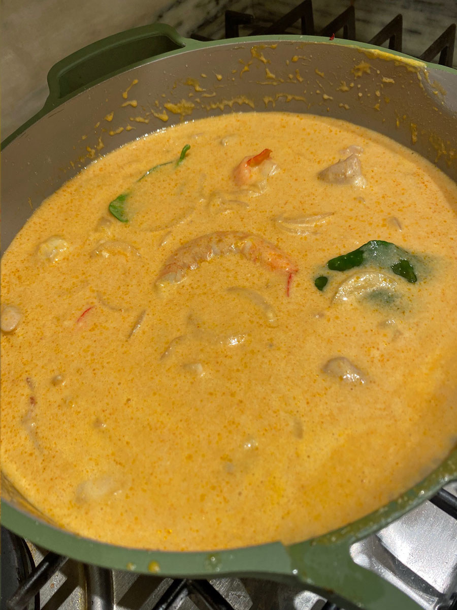 The mango coconut curry sauce simmering in a skillet.