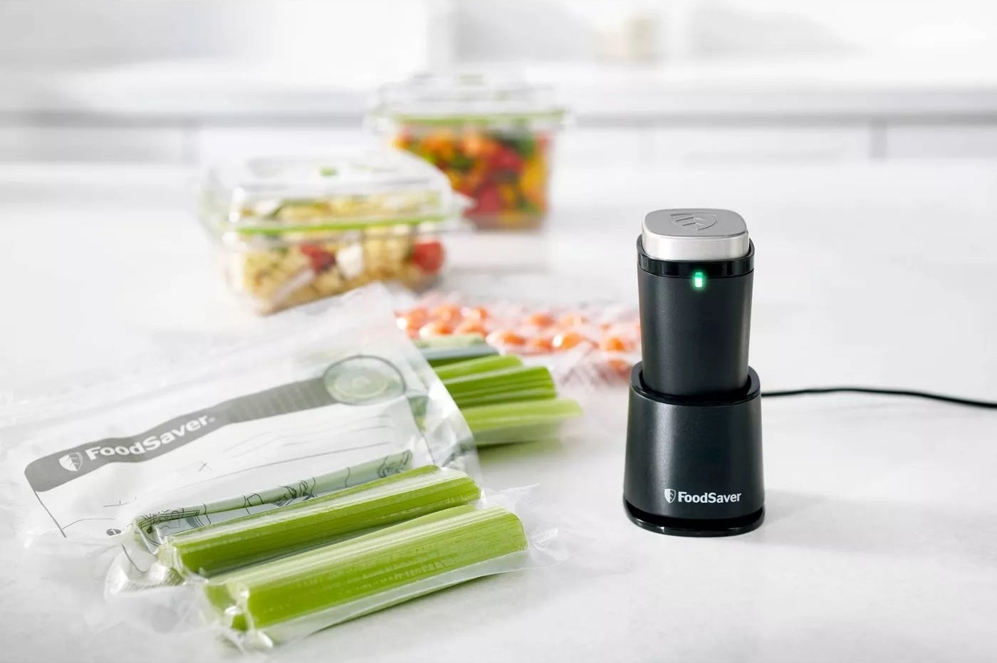 The vacuum sealer shown with bags of sealed vegetables