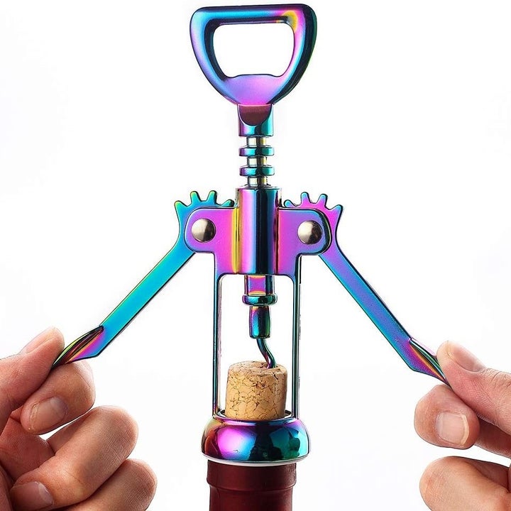 uncorking a wine bottle with the opener 