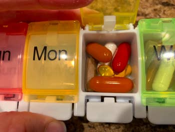A close up of the pills in the Tuesday compartment of a customer's AUVON iMedassist Weekly Pill Organizer