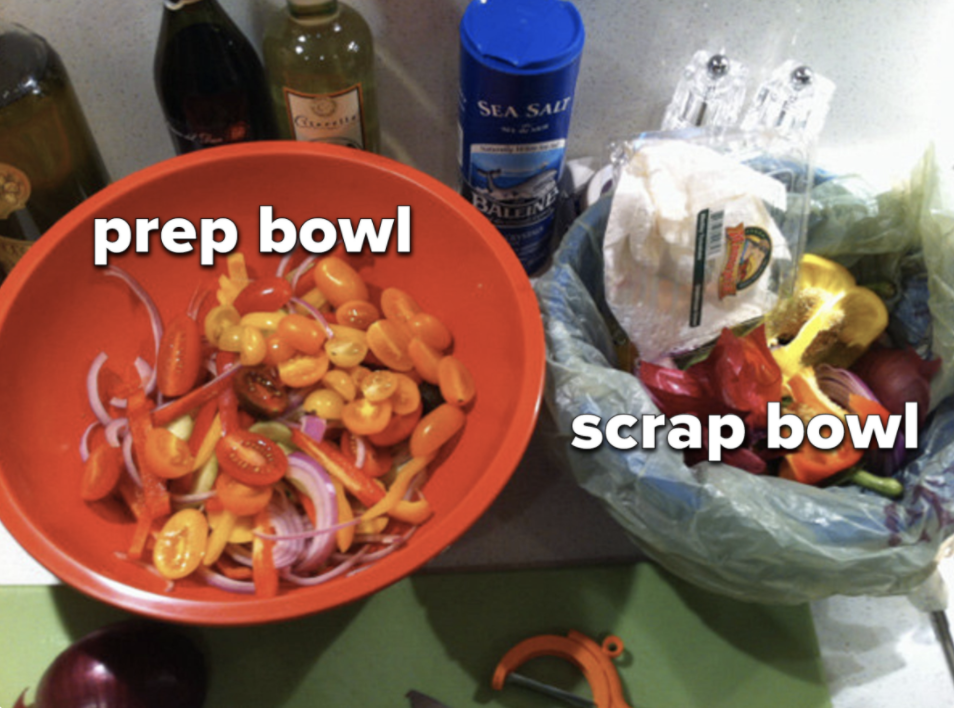 A cooking setup with a designated prep bowl and scrap bowl.