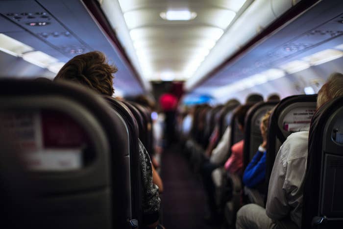 Airplane passengers in seats inside a commercial flight