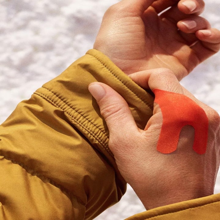 A coral-colored bandage in action