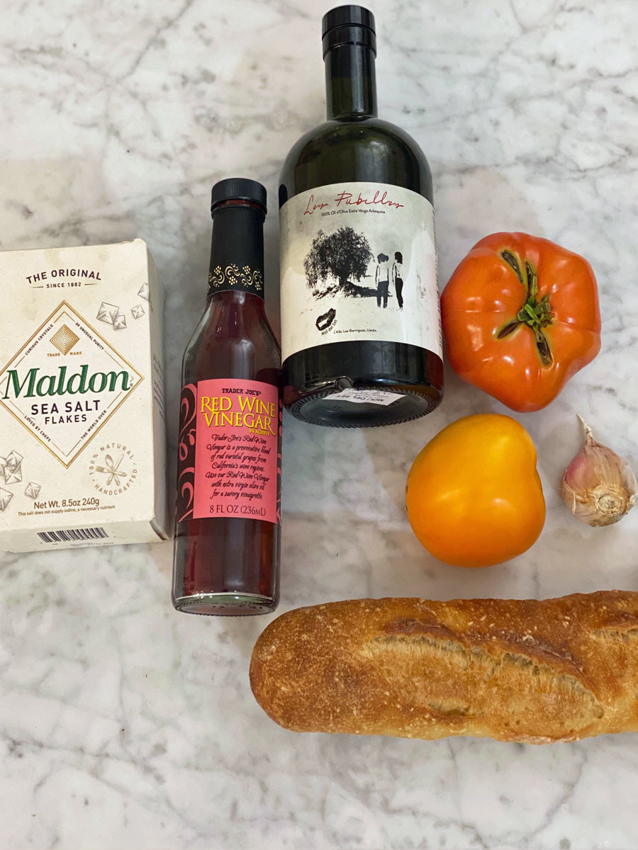 Ingredients for Spanish tomato bread on a countertop.