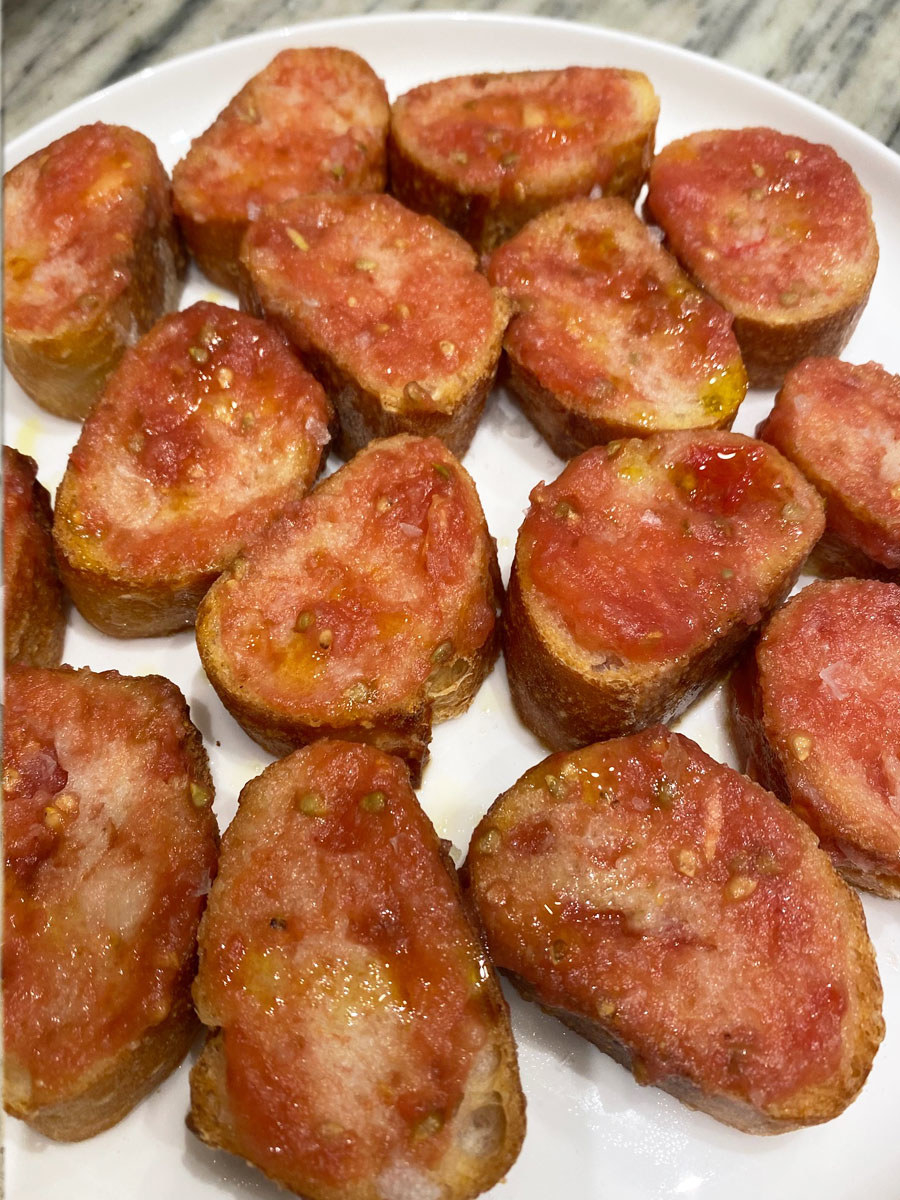 Sliced, toasted bread rubbed with tomato sauce and topped with olive oil and salt.